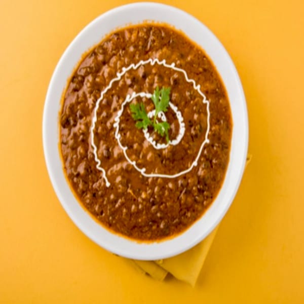 Chaat House's creamy Dal Makhani, garnished with a swirl of cream and fresh cilantro.