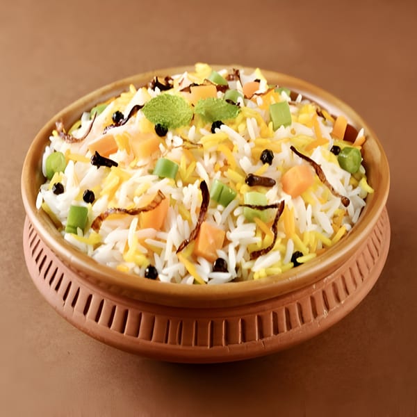 Colorful Indian biryani with rice, vegetables, and spices, served in a traditional clay pot.